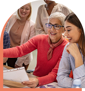 Picture of a group of people looking at a computer screen together.